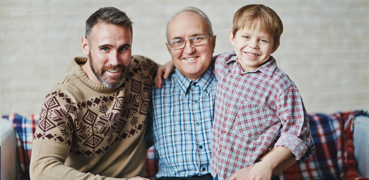 An older man and two younger boys posing for a picture.