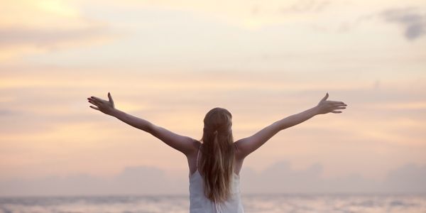 happy person with wide open arms in the beach