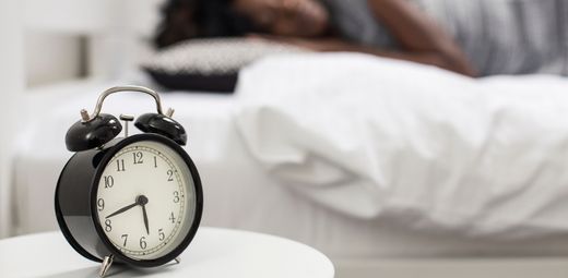 An alarm clock sitting on top of a white table