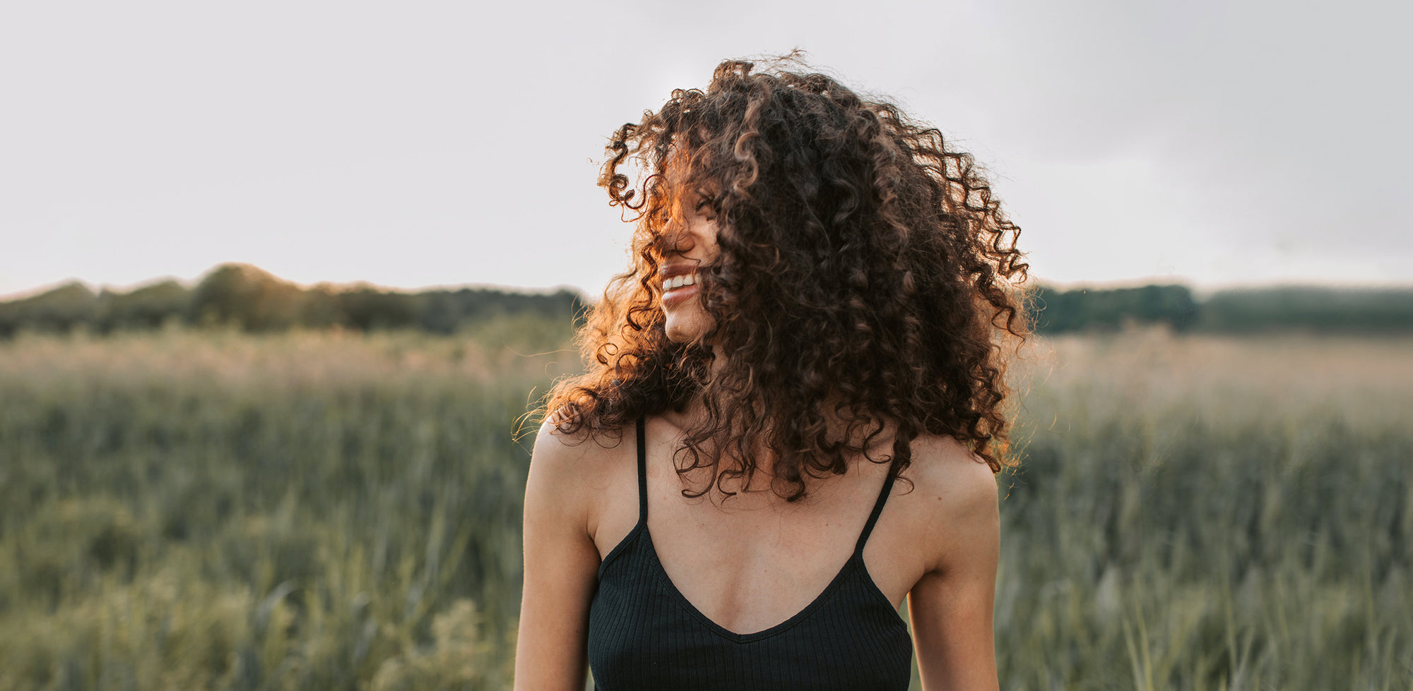 A woman standing in a field of tall grass