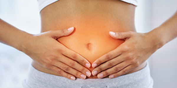 A woman holding her stomach with both hands