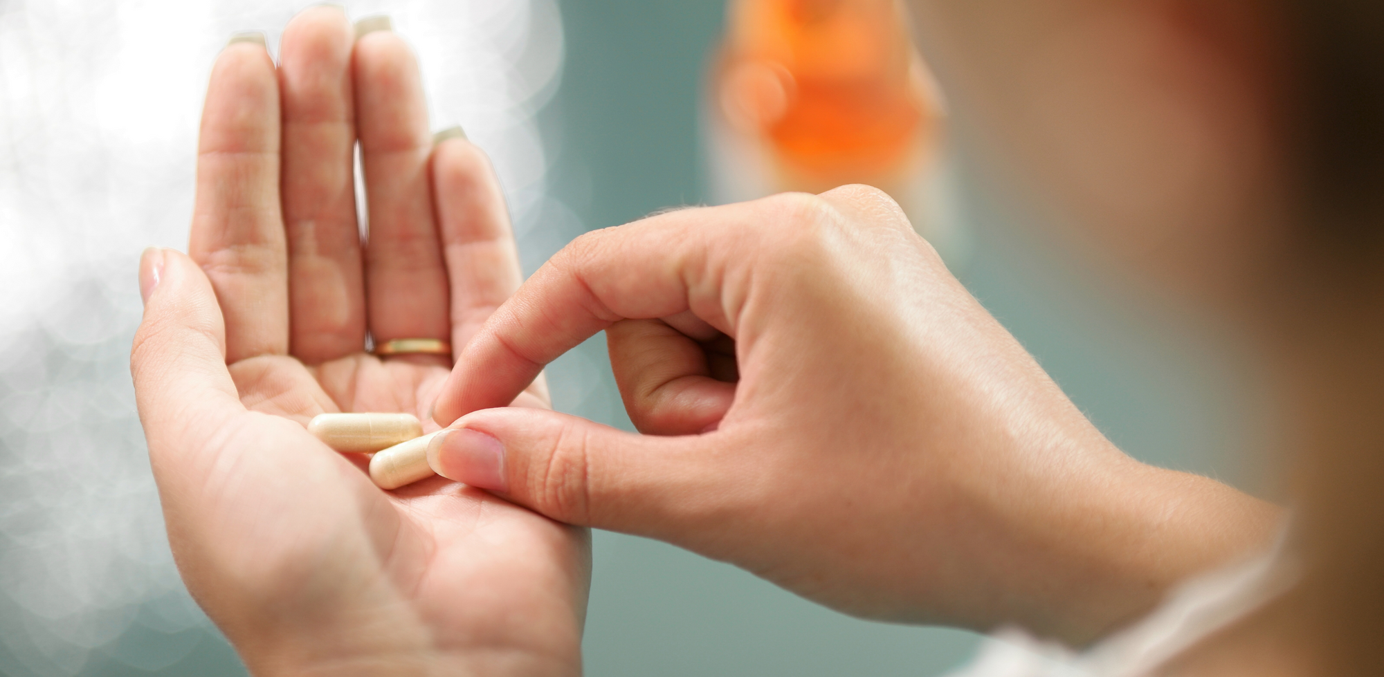 A person holding a multivitamins in their hand.