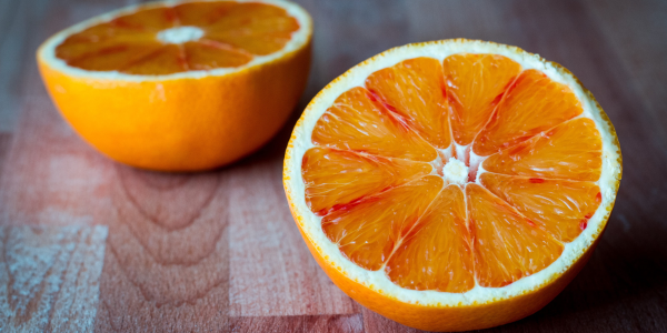 An orange cut in half sitting on a table