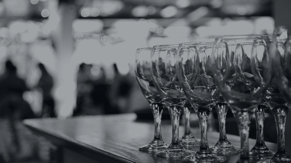 A row of wine glasses sitting on top of a bar