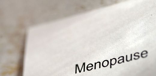 A close up of a piece of paper with the word menopause on it