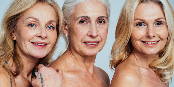 Three older women are posing for a picture