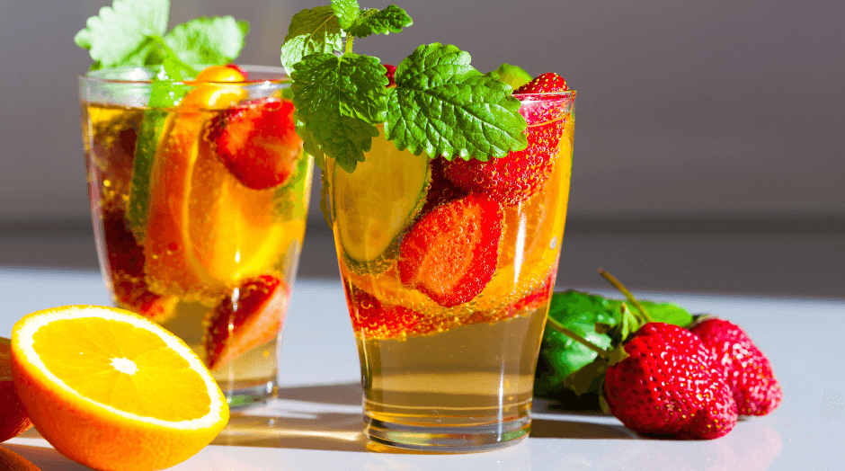 a couple of glasses filled with liquid and fruit