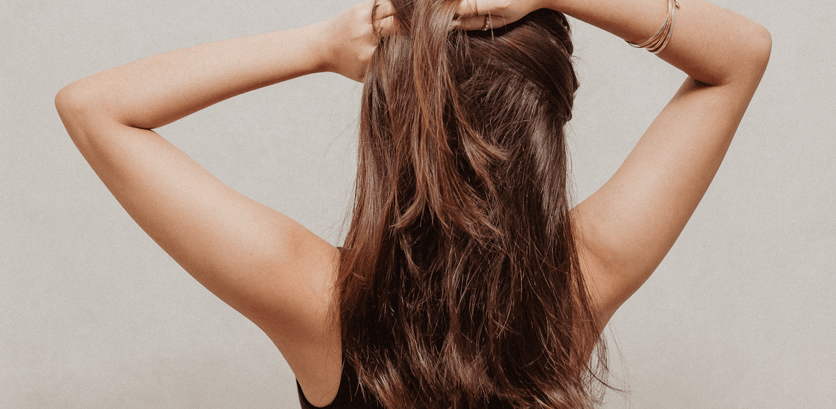 A woman with her hair in a ponytail.