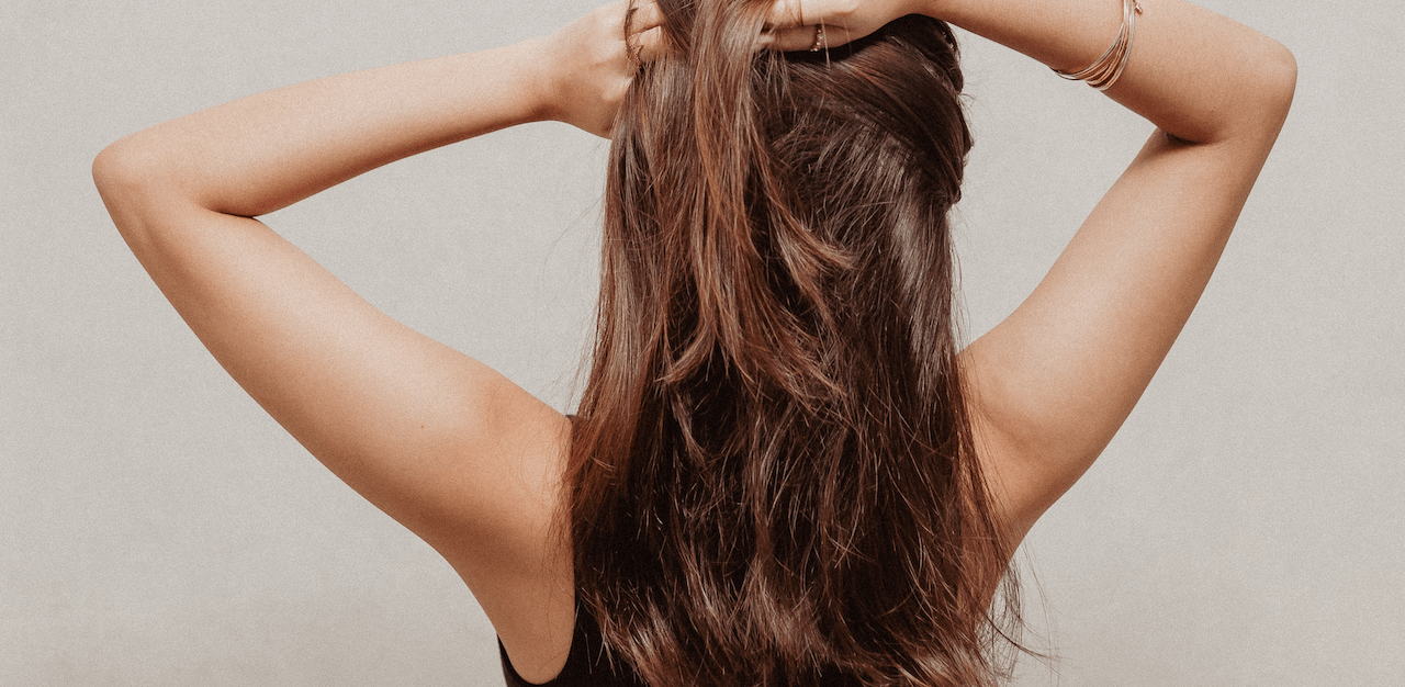 A woman with her hair in a ponytail.